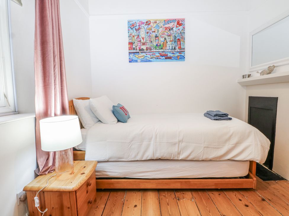 A bedroom with a bed and lamp at The Old School House in Windsor