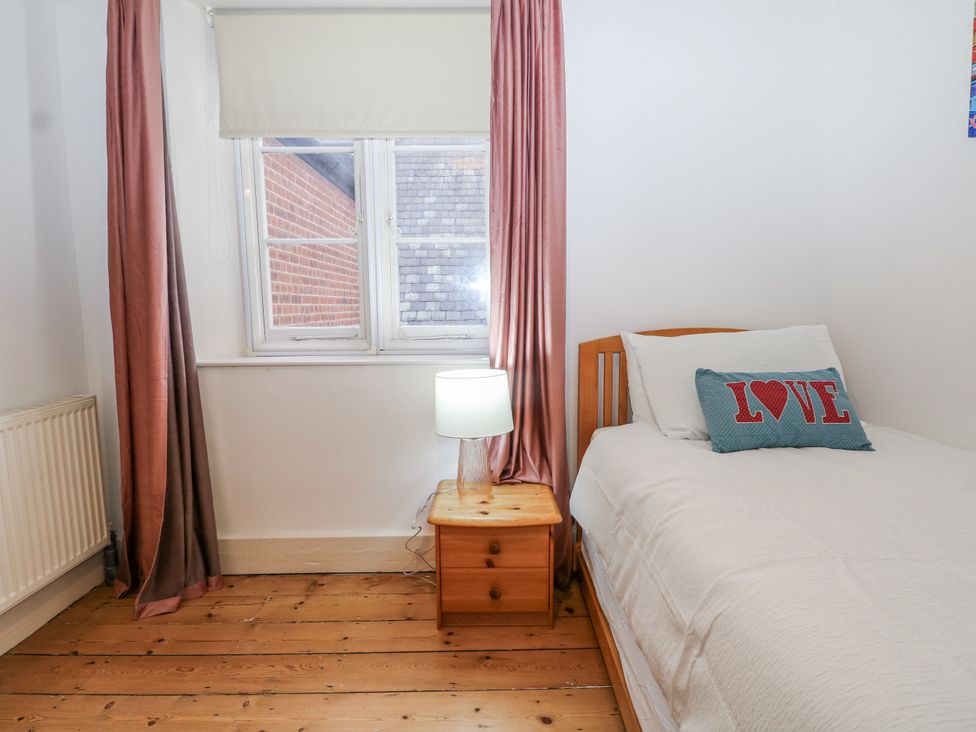 A bedroom with a single bed and a bedside table at The Old School House in Windsor