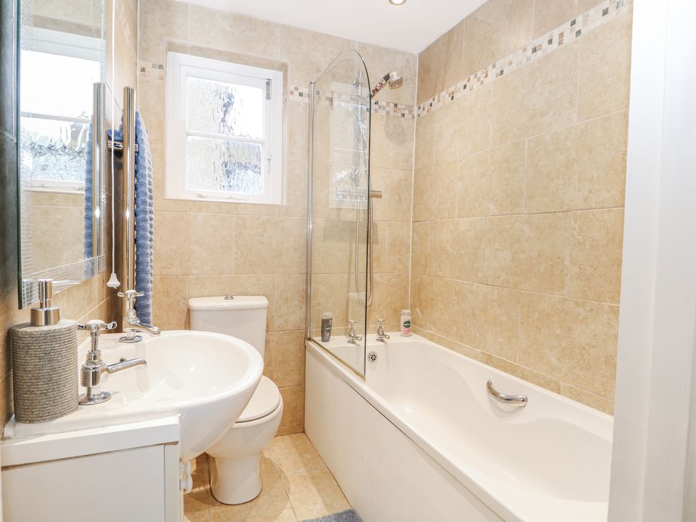 A bathroom with a bathtub and sink at The Old School House in Windsor