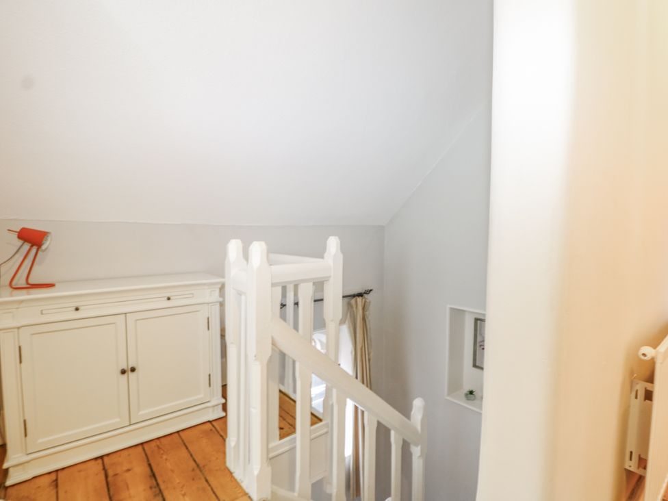 A staircase with a lamp and cabinet at The Old School House in Windsor