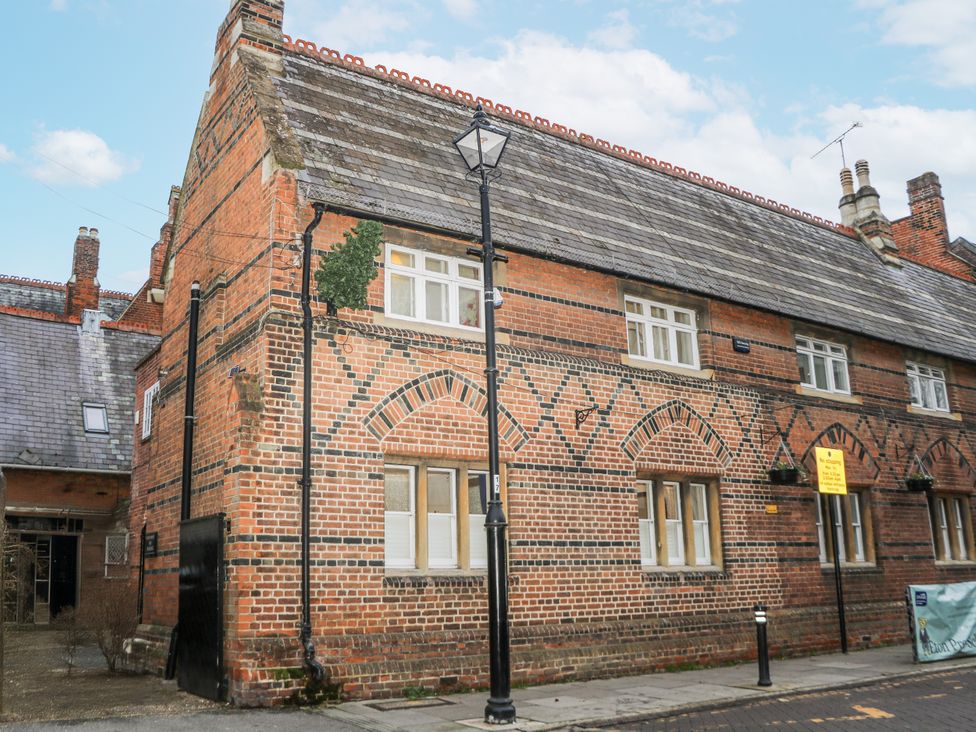 A brick building with windows and a lamp post at The Old School House in Windsor