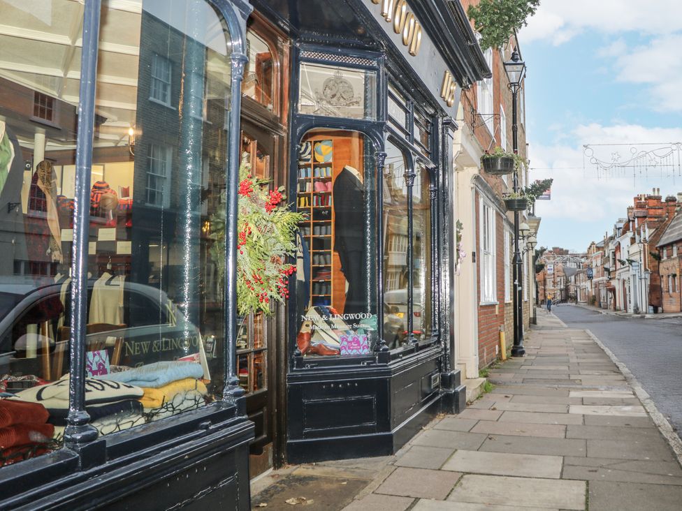 A storefront with clothing displays and a sidewalk at The Old School House in Windsor