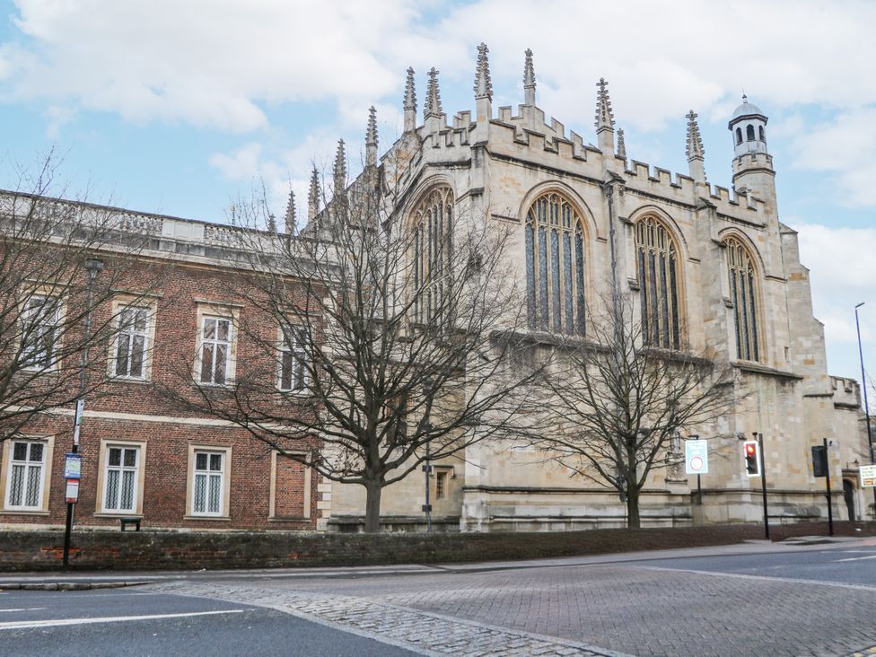 A historic building with large windows and trees on the side at The Old School House in Windsor
