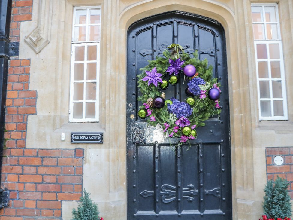 An entrance with a black door, wreath, and windows at The Old School House in Windsor