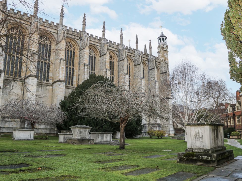 An outdoor area with trees and tombstones next to a building at The Old School House in Windsor
