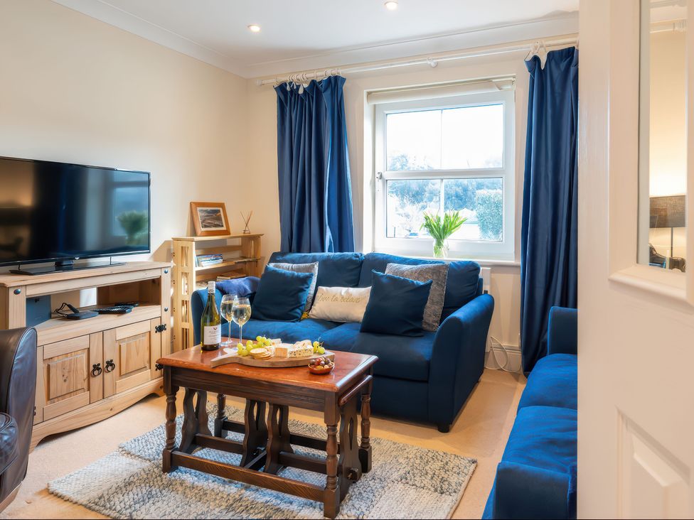 A living room with a television and seating area at 17 Solent Landing in Bembridge
