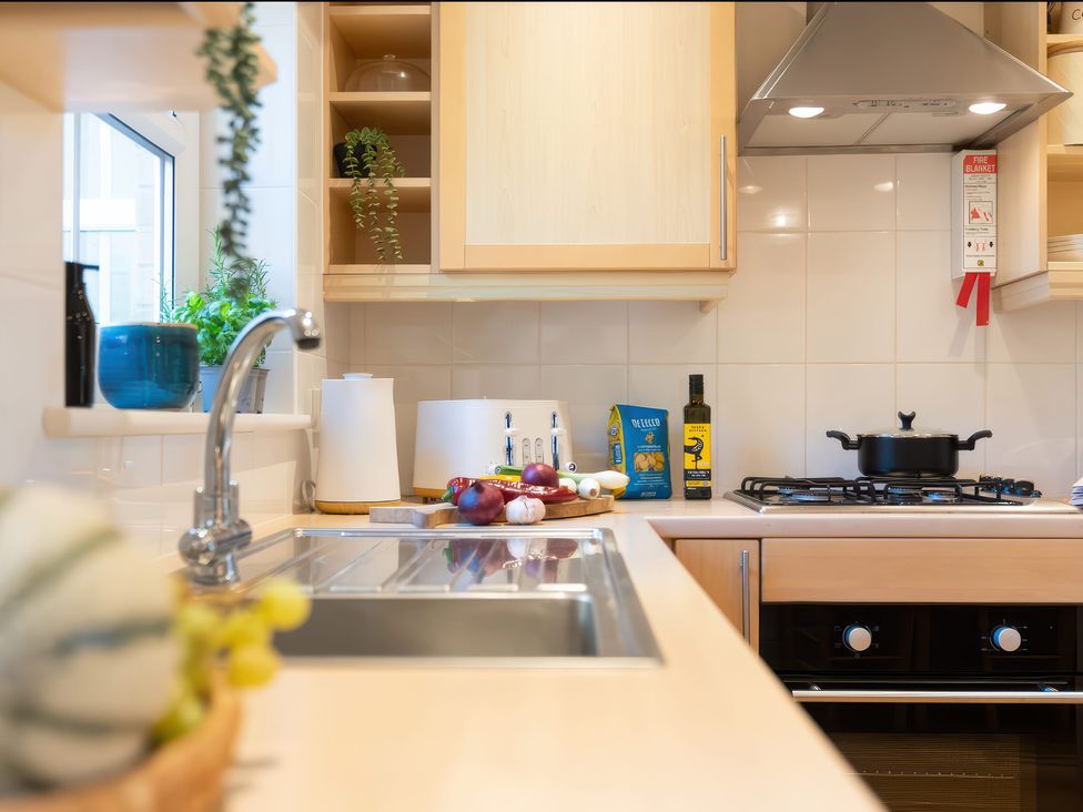 A kitchen with sink and gas stove at 17 Solent Landing in Bembridge