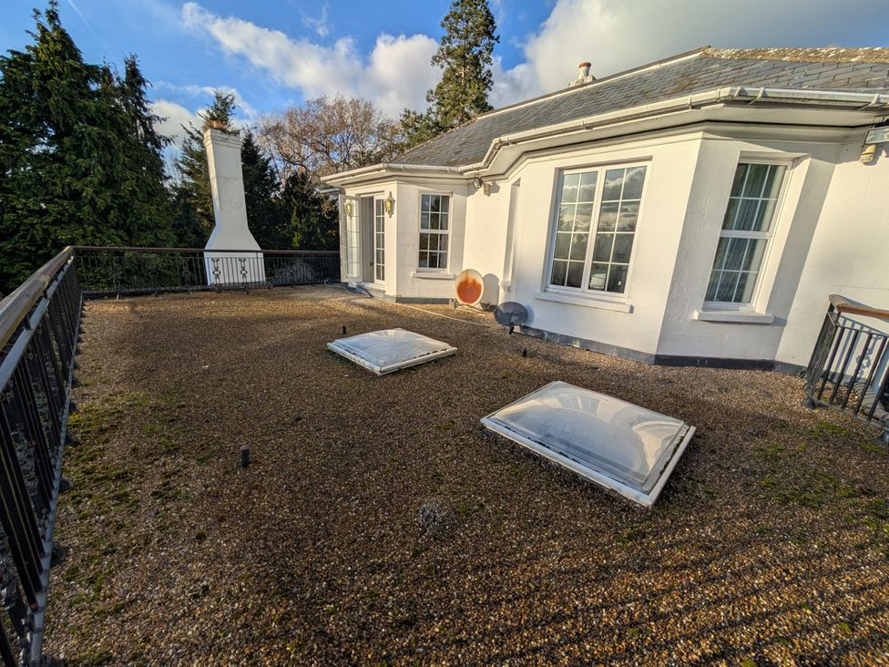 An outdoor area with a balcony and skylights at Heath Lodge Iver