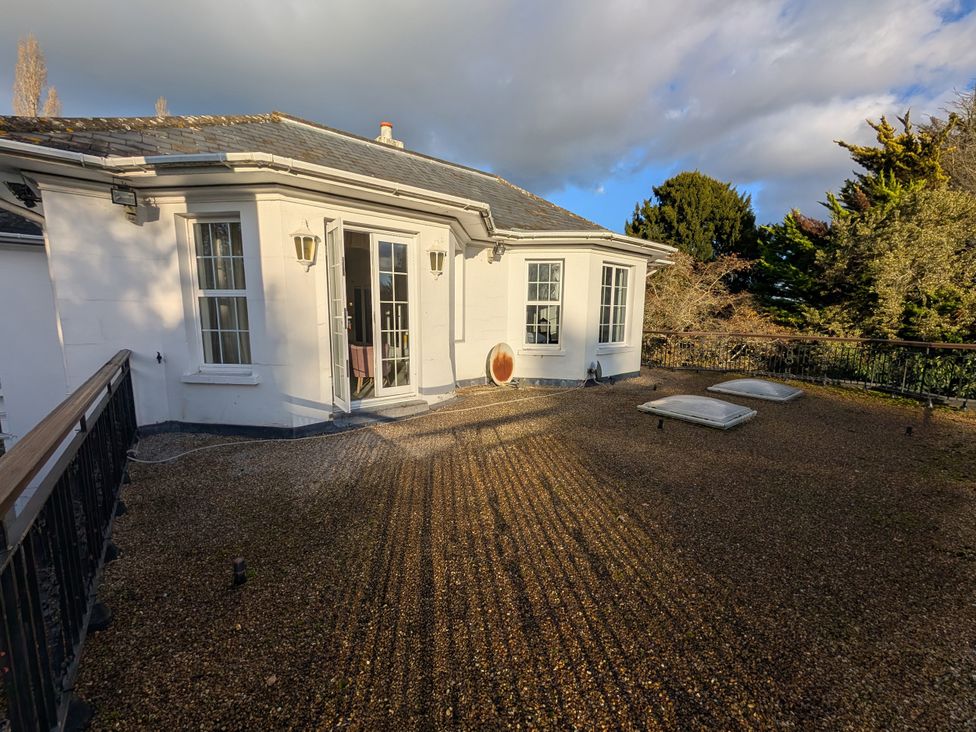 An outdoor area with a balcony and skylights at Heath Lodge Iver