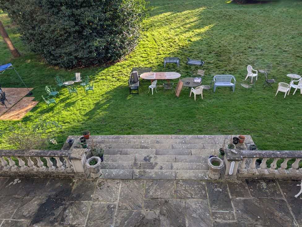 A garden with seating and a table at Heath Lodge in Iver