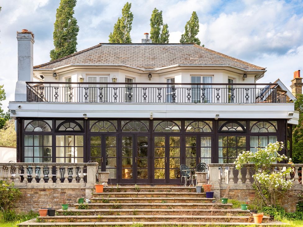 A house with a balcony and stairway at Violet House in Iver