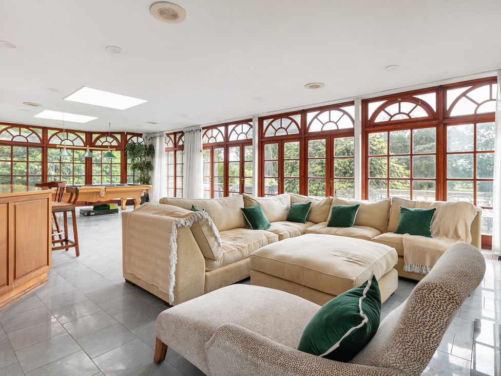 A living room with a sofa and pool table at Violet House in Iver