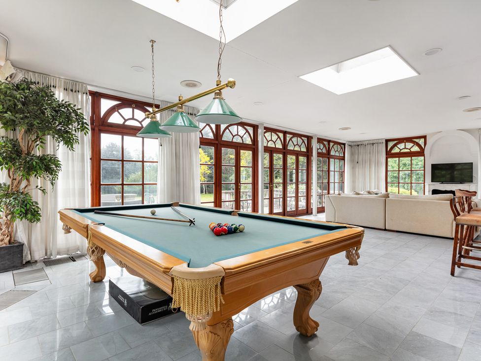 A game room with a pool table and seating at Violet House in Iver