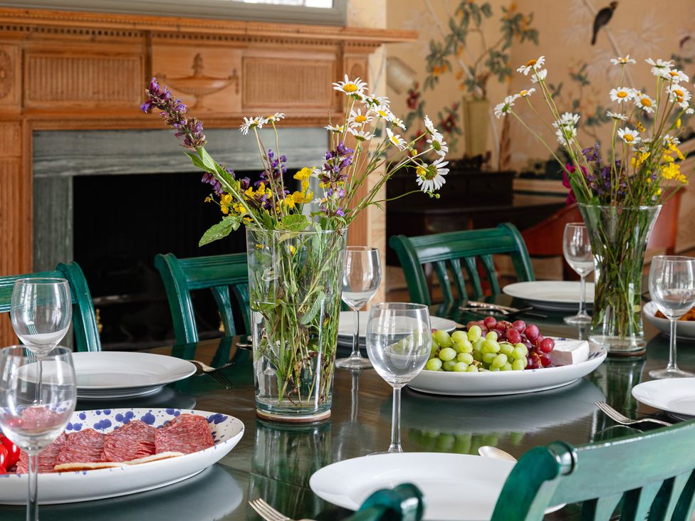 A dining room set with a table of food at Violet House in Iver