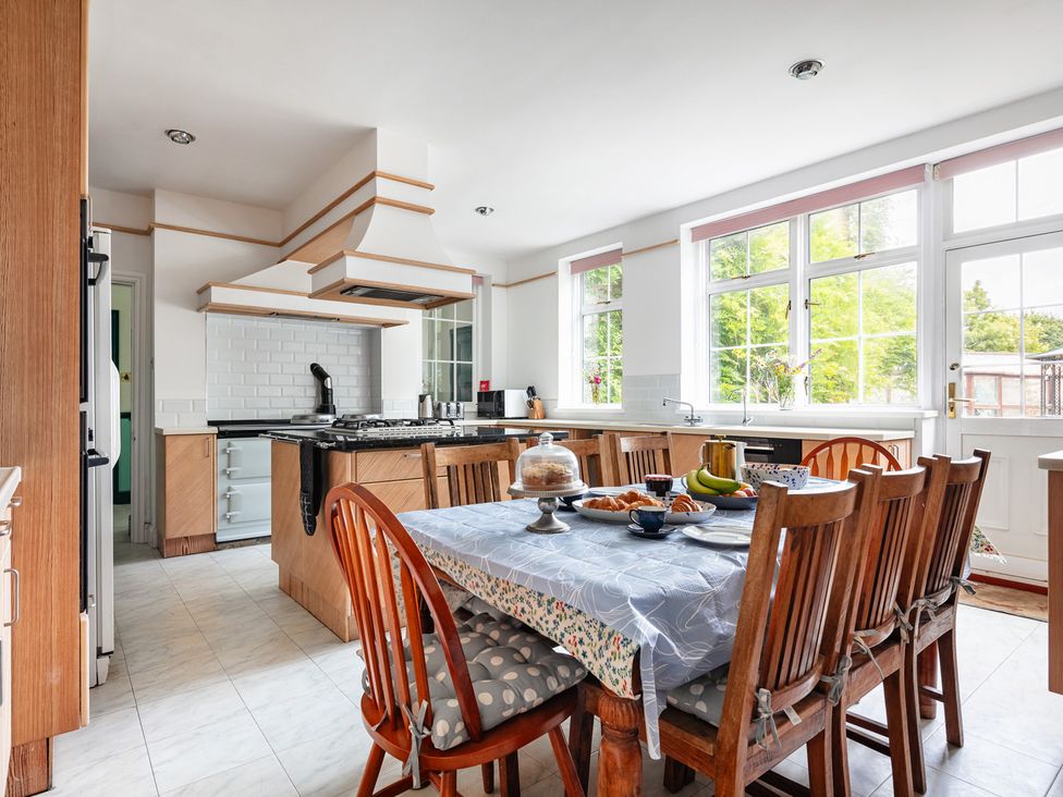 A kitchen with a table and chairs at Violet House in Iver