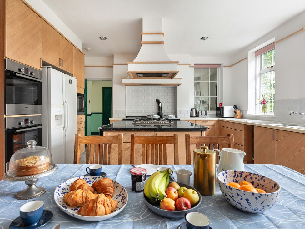 A kitchen with a table set for breakfast at Violet House in Iver