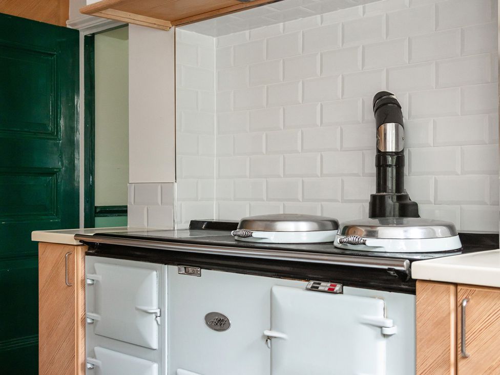 A kitchen with a stove and black chimney at Violet House in Iver