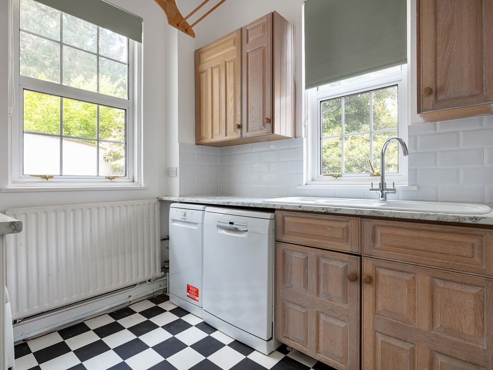 A kitchen with a sink and dishwasher at Violet House in Iver