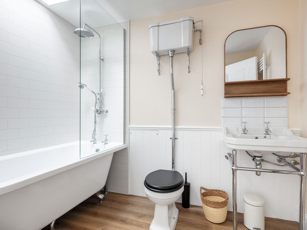 A bathroom with a bathtub, toilet, sink, and shower at Violet House in Iver