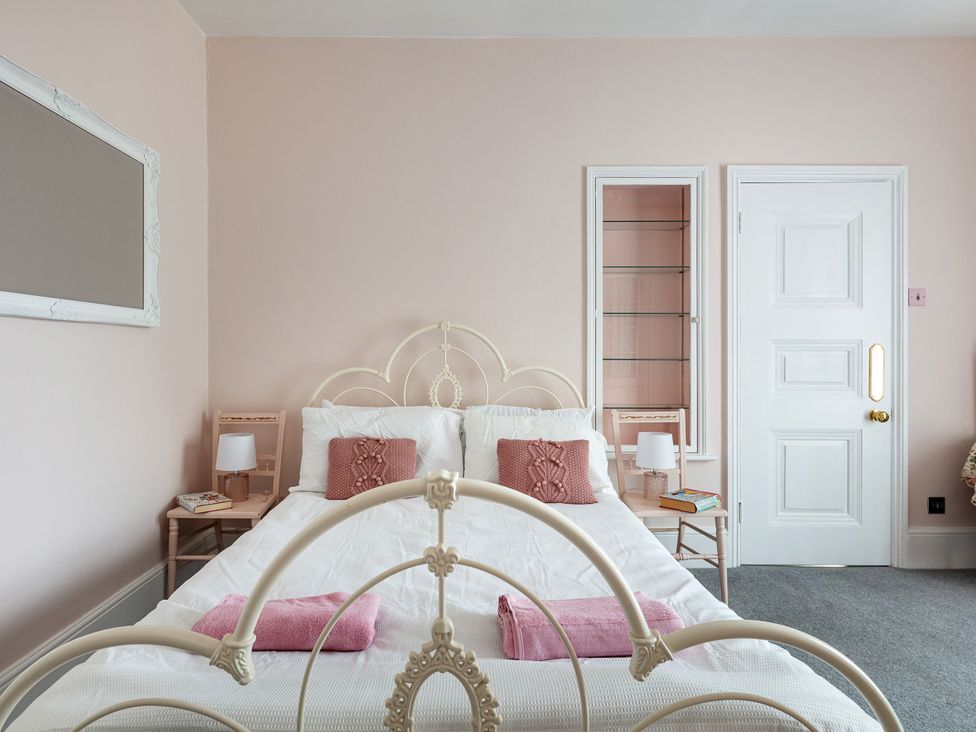 A bedroom with a bed and nightstand at Violet House in Iver