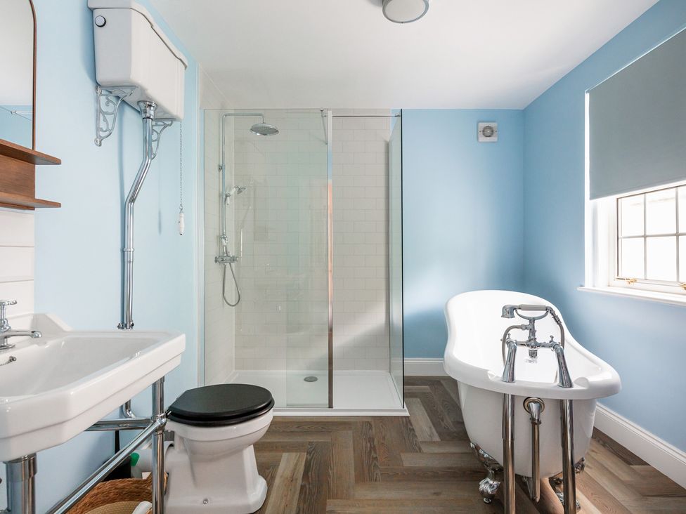 A bathroom with a shower, bathtub, sink, and toilet at Violet House Iver