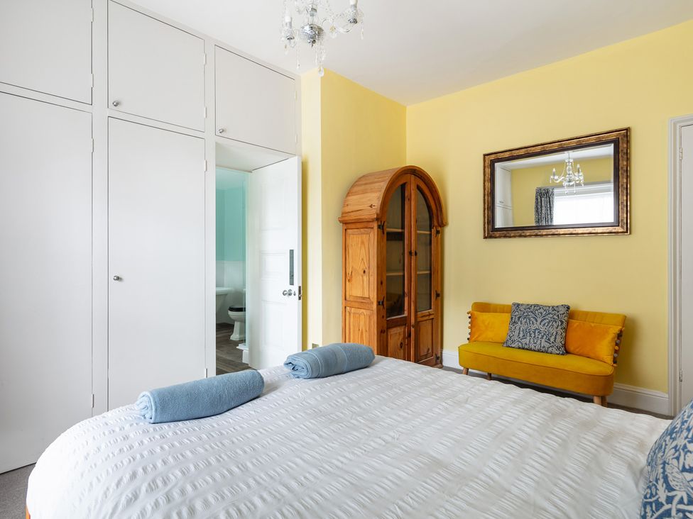 A bedroom with a bed and wardrobe at Violet House in Iver