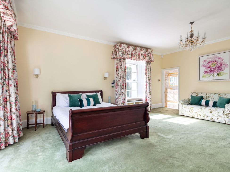A bedroom with a bed and a couch at Violet House in Iver