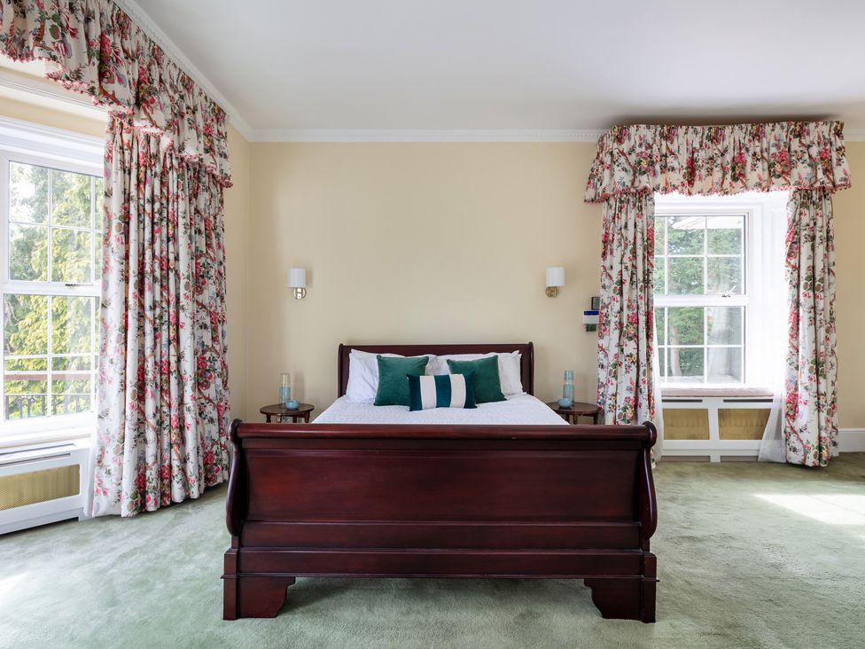A bedroom with a bed and curtains at Violet House in Iver
