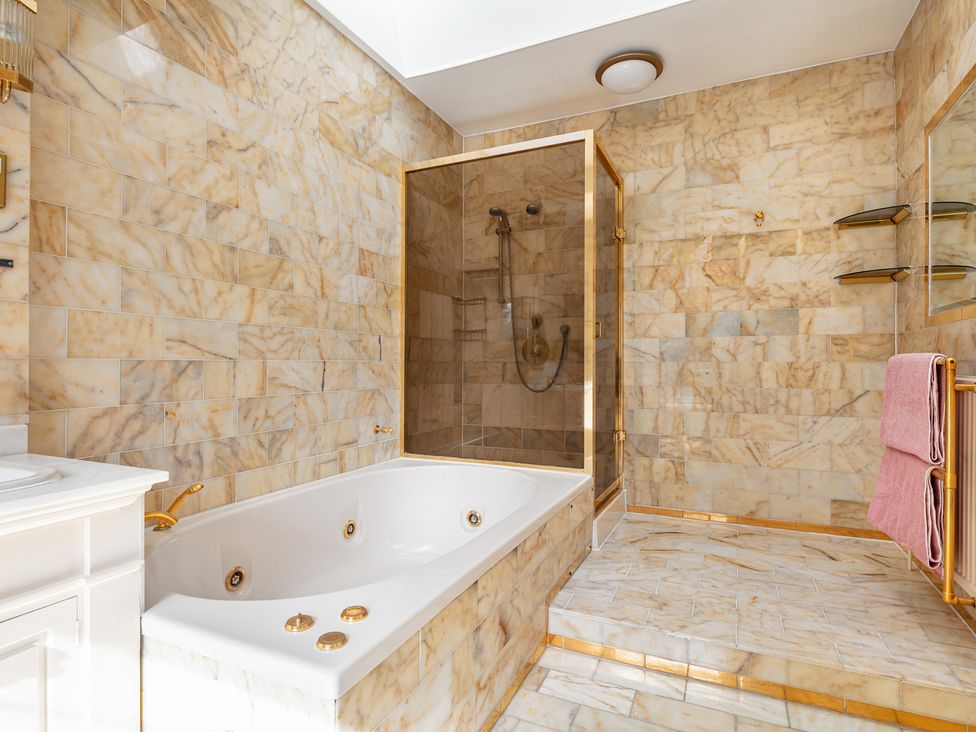A bathroom with a bathtub and shower at Violet House in Iver
