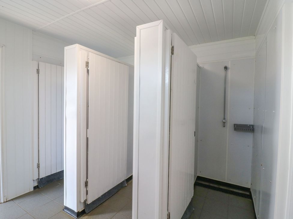 A bathroom with shower stalls at Bluebell Lodge in Hastings