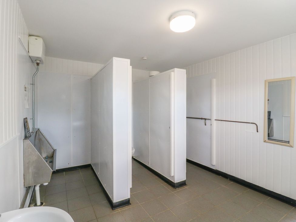 A bathroom with toilet and sink at Bluebell Lodge in Hastings