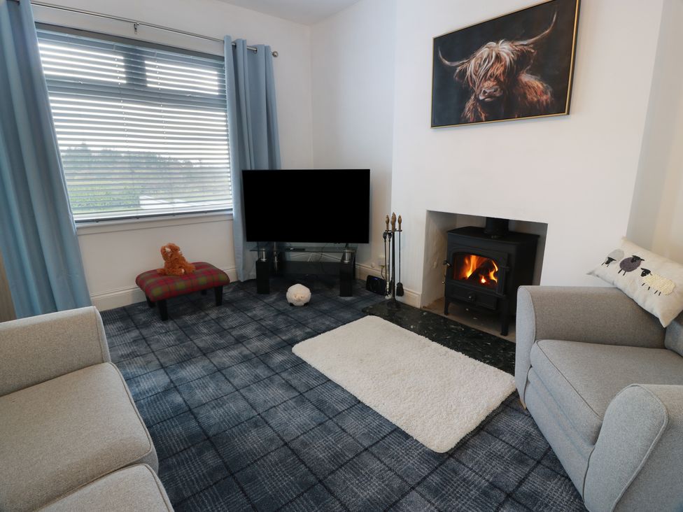 A living room with a sofa and television at Marchdyke Farm Cottage Dalton near Annan