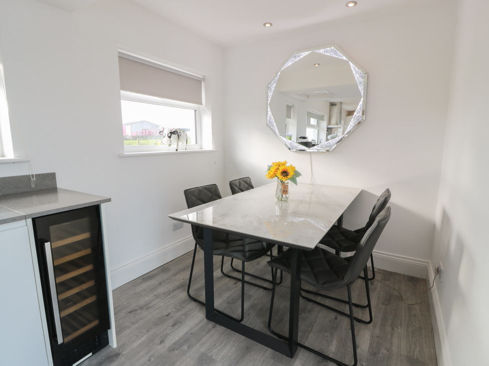 A dining room with a table and chairs at Marchdyke Farm Cottage in Dalton near Annan