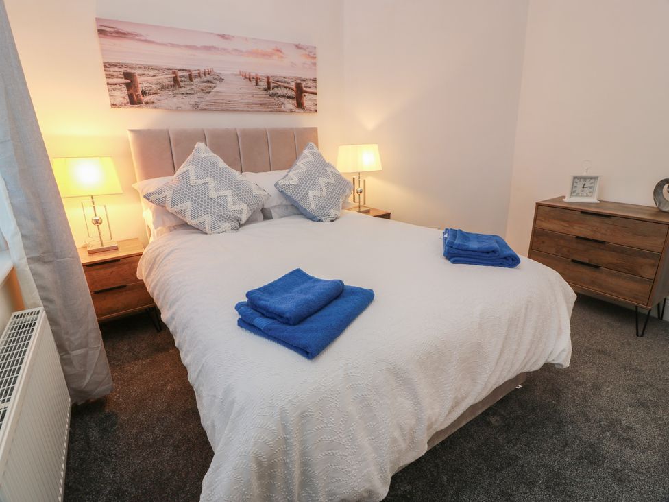 A bedroom with a bed and bedside tables at Marchdyke Farm Cottage in Dalton near Annan