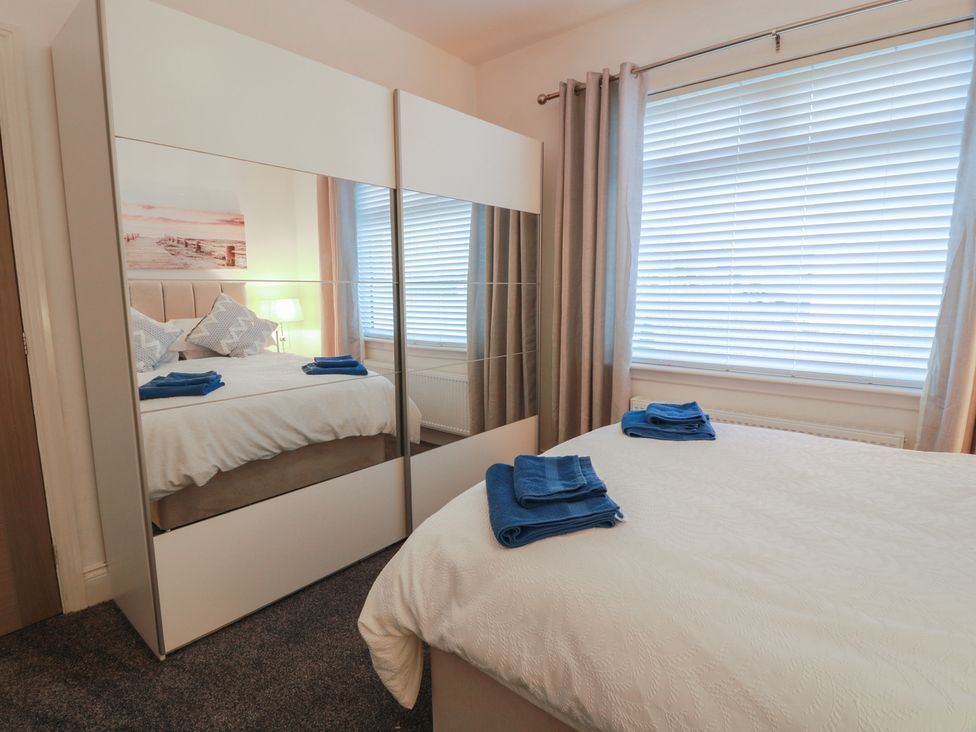 A bedroom with a bed and towels on it at Marchdyke Farm Cottage Dalton near Annan