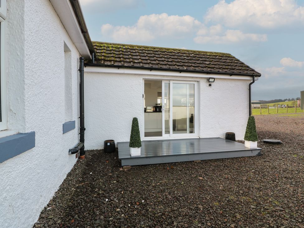 An outdoor area with a deck and plants at Marchdyke Farm Cottage in Dalton near Annan