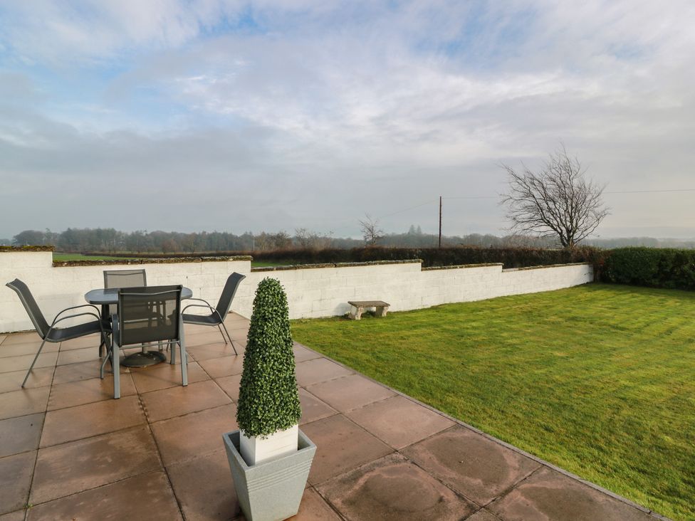 A garden with a table and chairs at Marchdyke Farm Cottage, Dalton near Annan