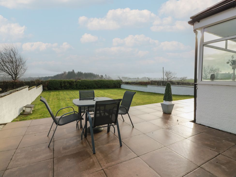 A garden with a table and chairs at Marchdyke Farm Cottage in Dalton near Annan