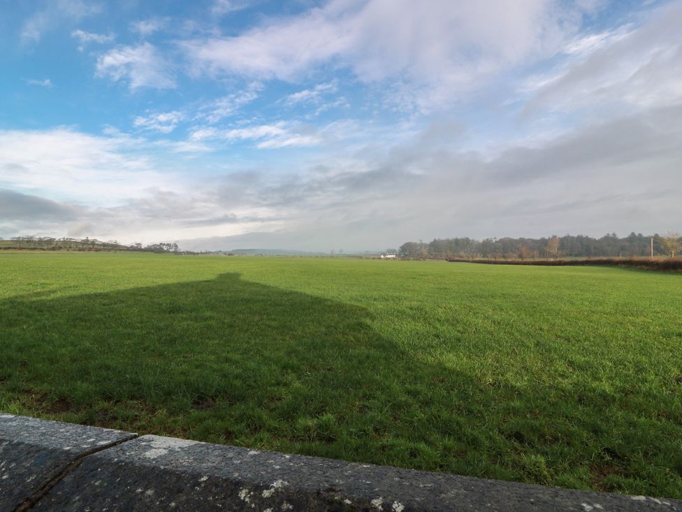 A field with grass and clouds in the sky at Marchdyke Farm Cottage in Dalton near Annan