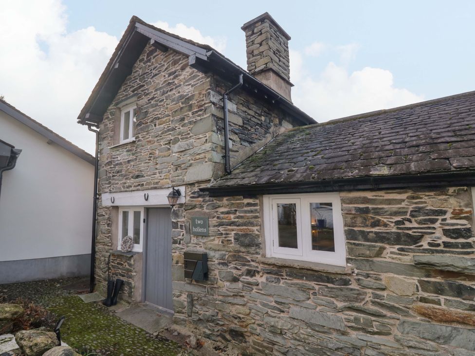 An exterior view of a stone house with a chimney at Two Hollens Ambleside