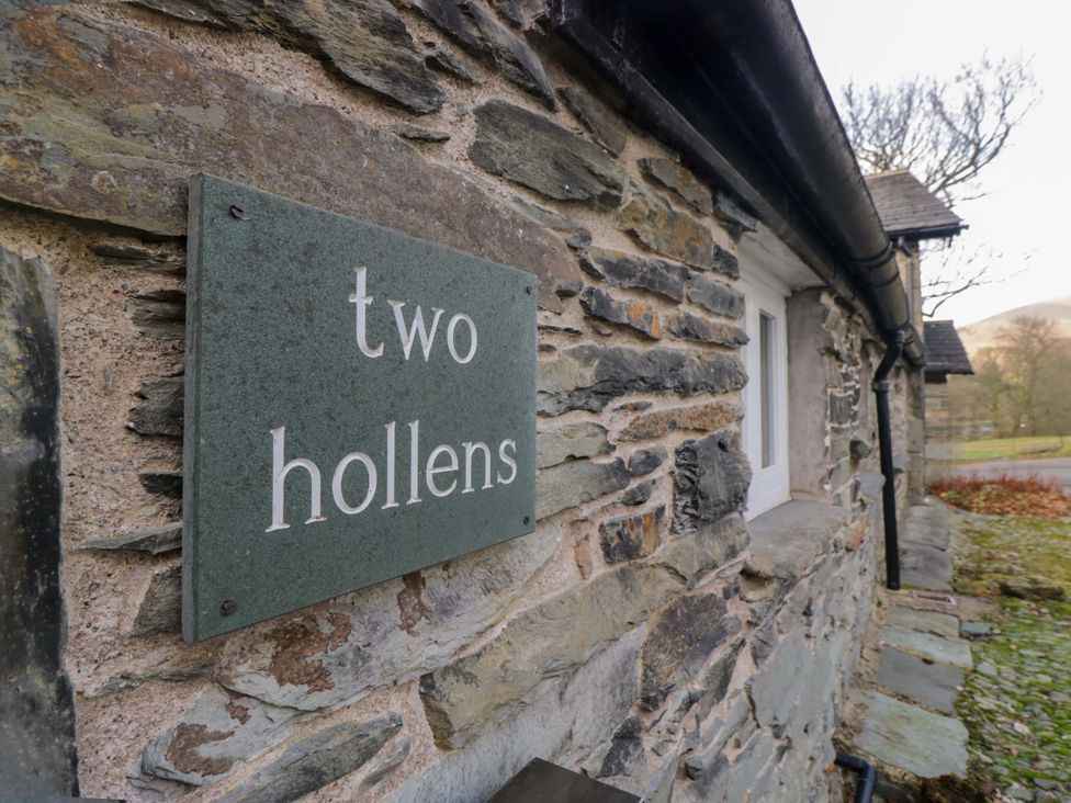 A sign on a stone wall at Two Hollens in Ambleside