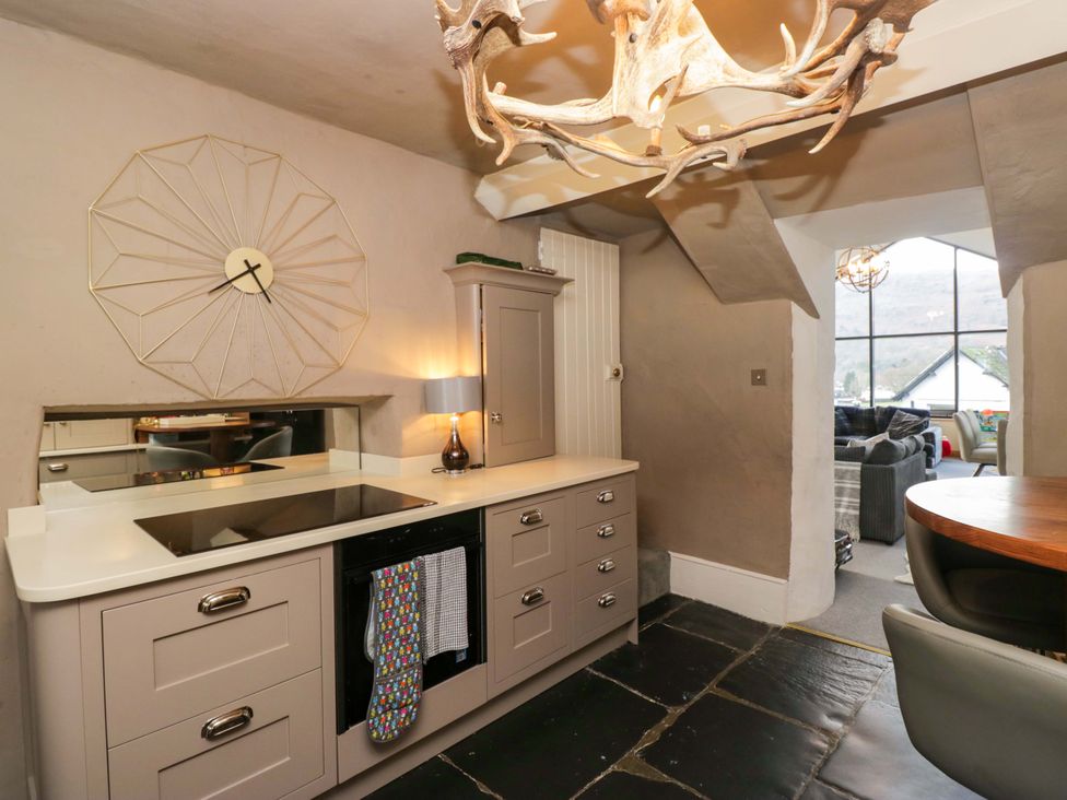 A kitchen with cabinets and a stove at Two Hollens in Ambleside