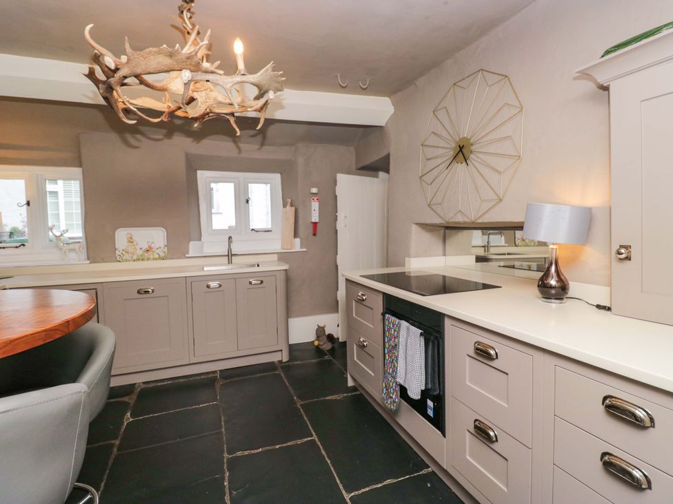 A kitchen with cabinets and a sink at Two Hollens in Ambleside