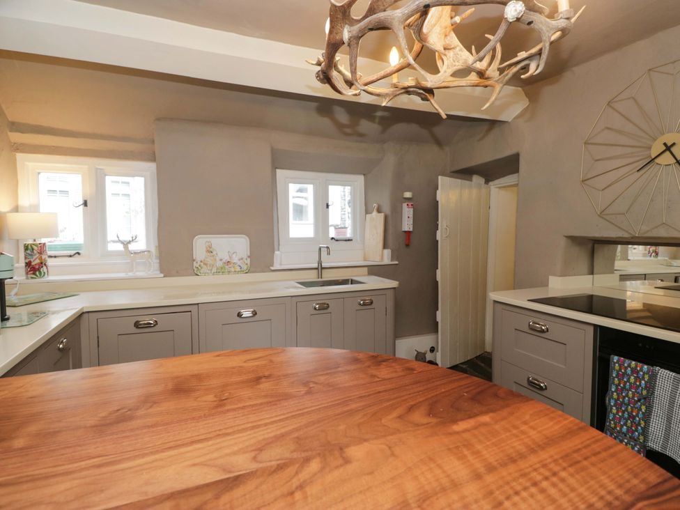 A kitchen with cupboards and a sink at Two Hollens in Ambleside