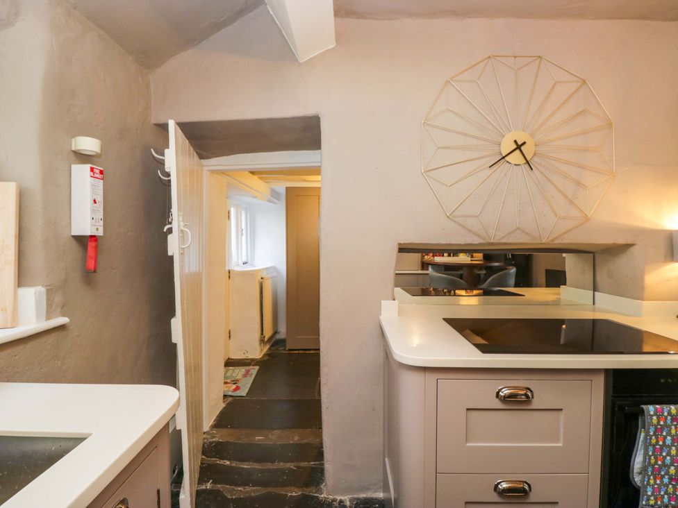 A kitchen with a countertop and a door at Two Hollens in Ambleside