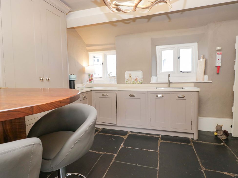 A kitchen with cabinets and a sink at Two Hollens in Ambleside