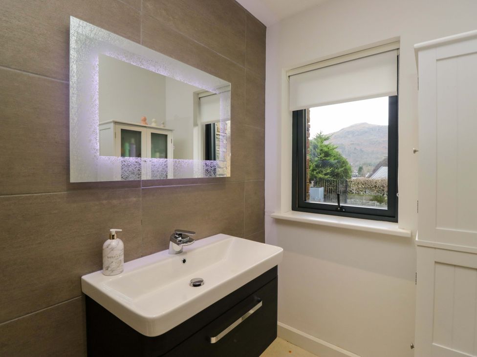 A bathroom with a sink and mirror at Two Hollens in Ambleside