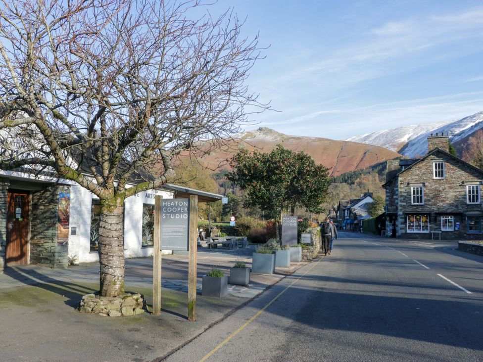 An outdoor scene with buildings and a sign at Two Hollens in Ambleside