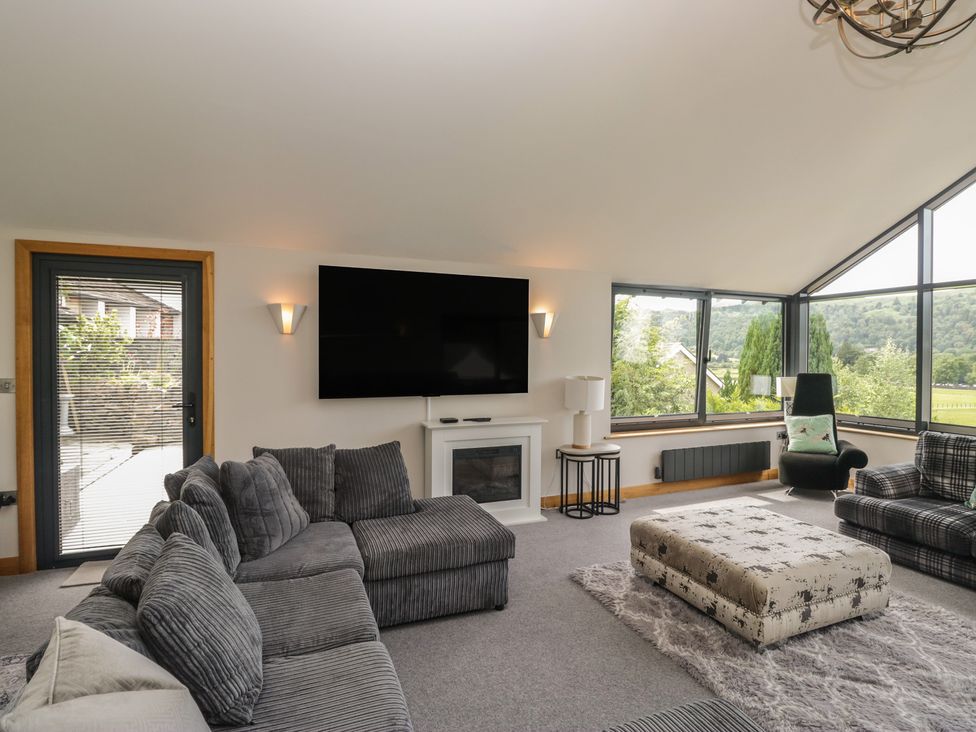 A living room with a television and sofa at Two Hollens in Grasmere