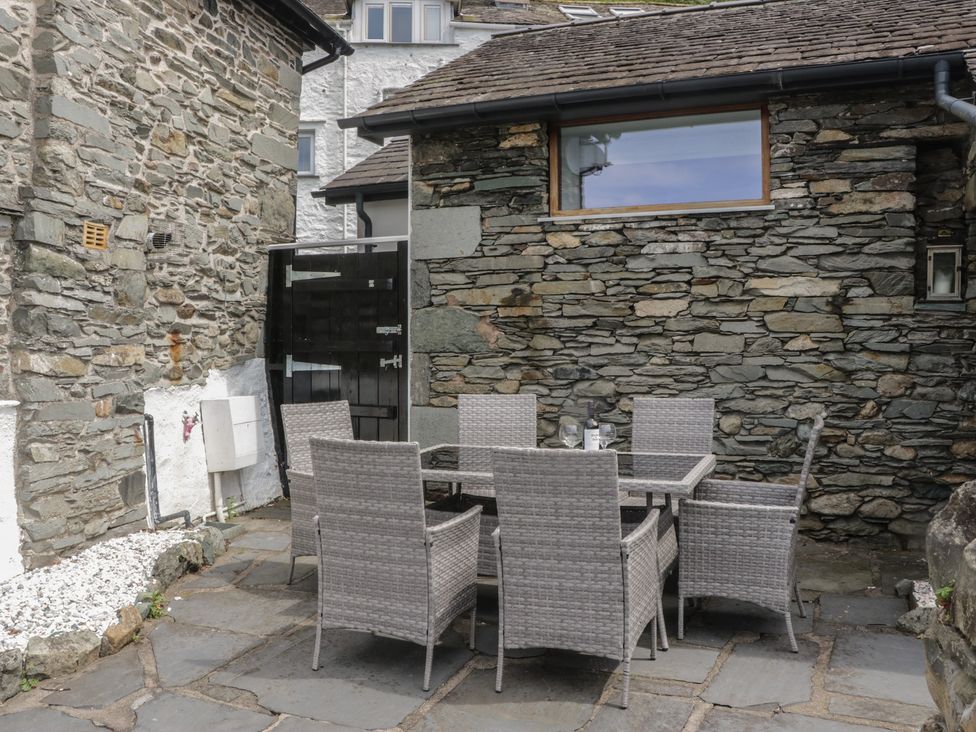 An outdoor dining area with a table and chairs at Two Hollens in Grasmere